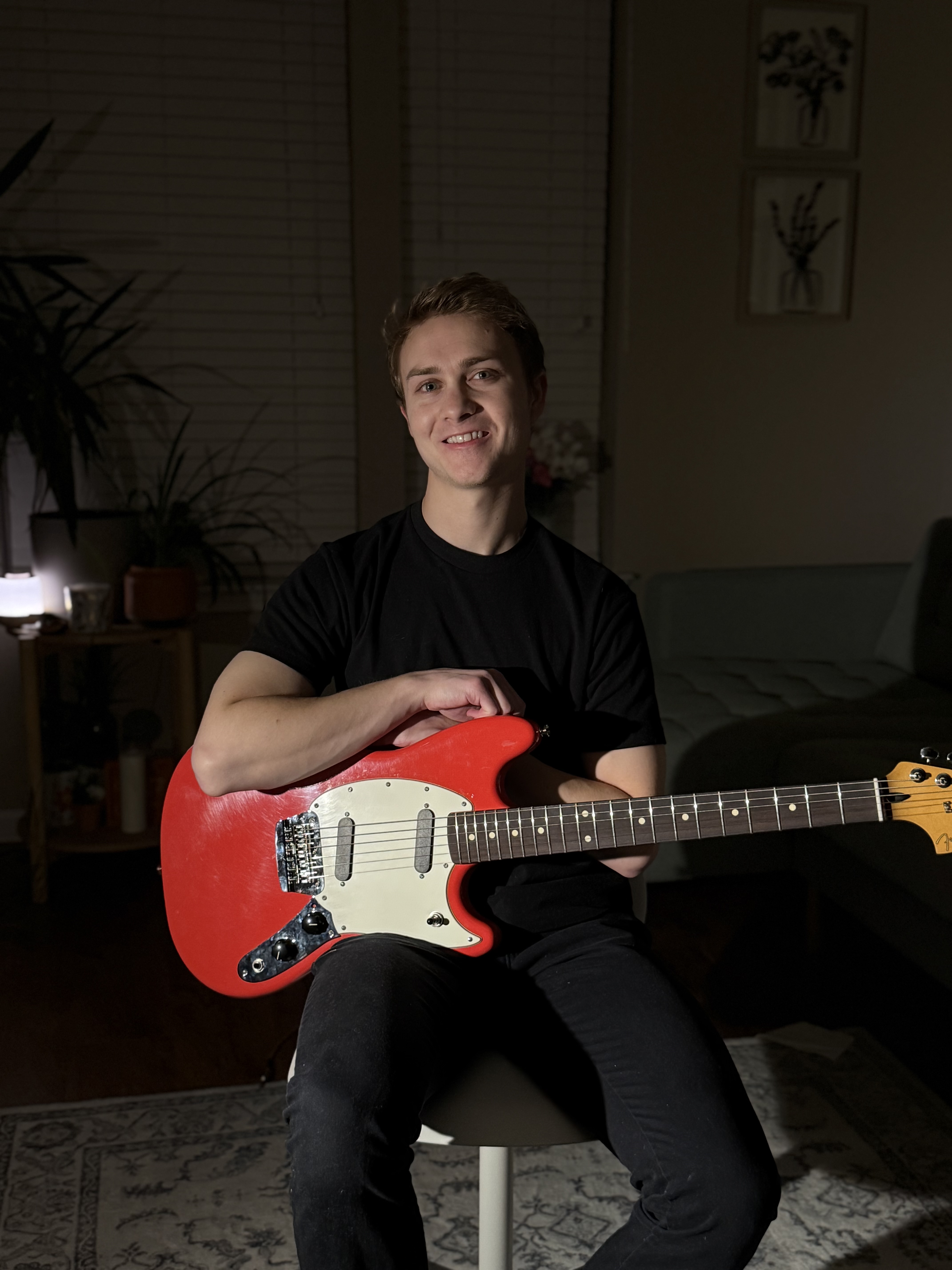 Jamie playing an electric guitar.